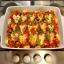 A tray of halloumi and chickpea bake with the halloumi cut into heart shapes