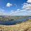 A panoramic view over Ullswater Lake from the top of our walk. The sun is shining and the sky is blue.