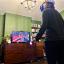 Charlotte stood in our living room playing Beat Saber