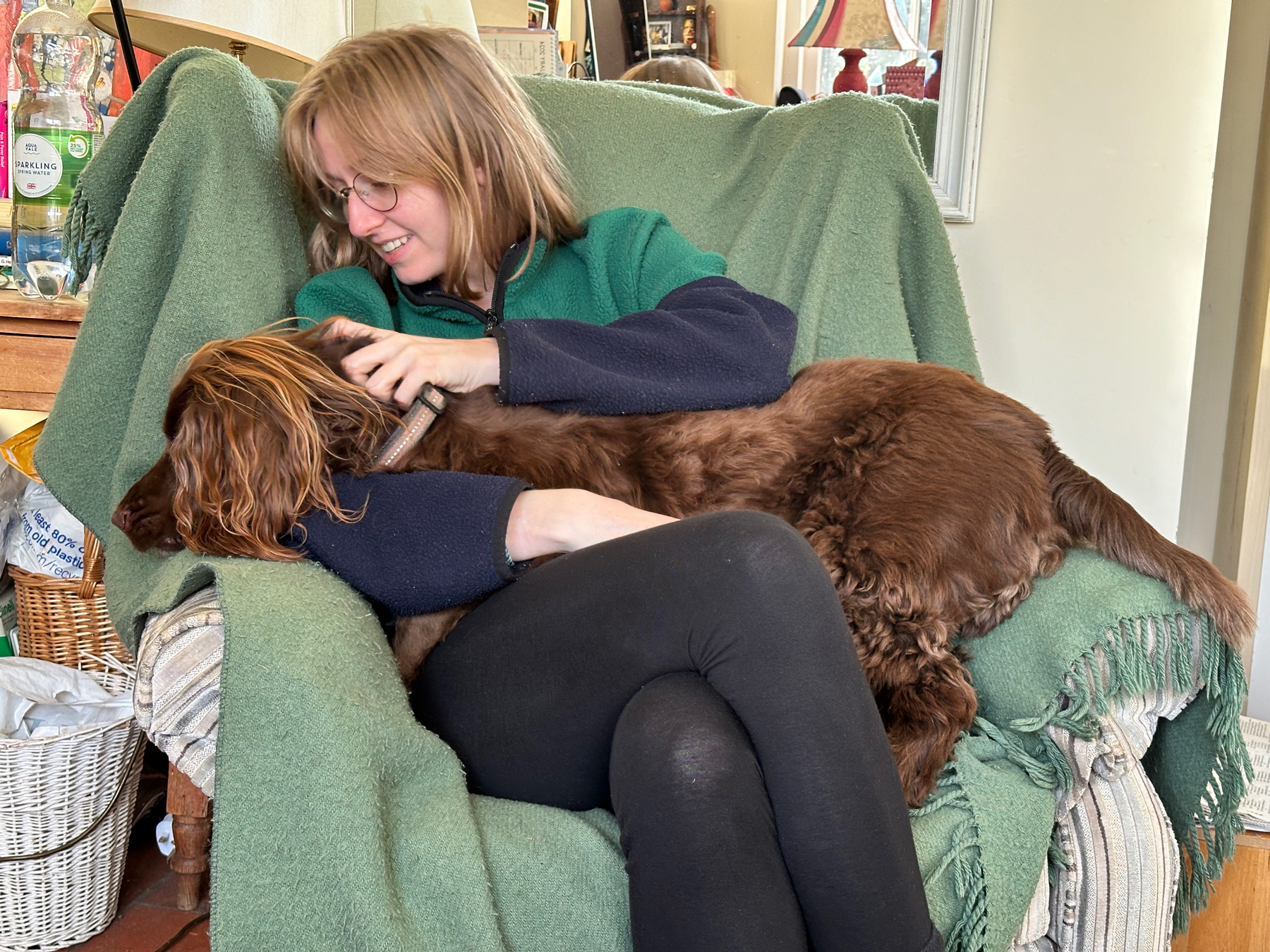 Charlotte sat on an armchair with a spaniel (Bertie) in her lap