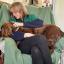 Charlotte sat on an armchair with a spaniel (Bertie) in her lap