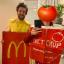 Rowan and Charlotte dressed as takeaway items. Rowan is dressed as McDonalds fries, wearing a yellow T-Shirt with chips drawn onto it and a large red box. Charlotte is dressed as a tub of ketchup in a painted box.
