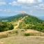 A sunny view across the ridge of the Malvern hills, looking out towards Worcestershire beacon - a large hill in the distance