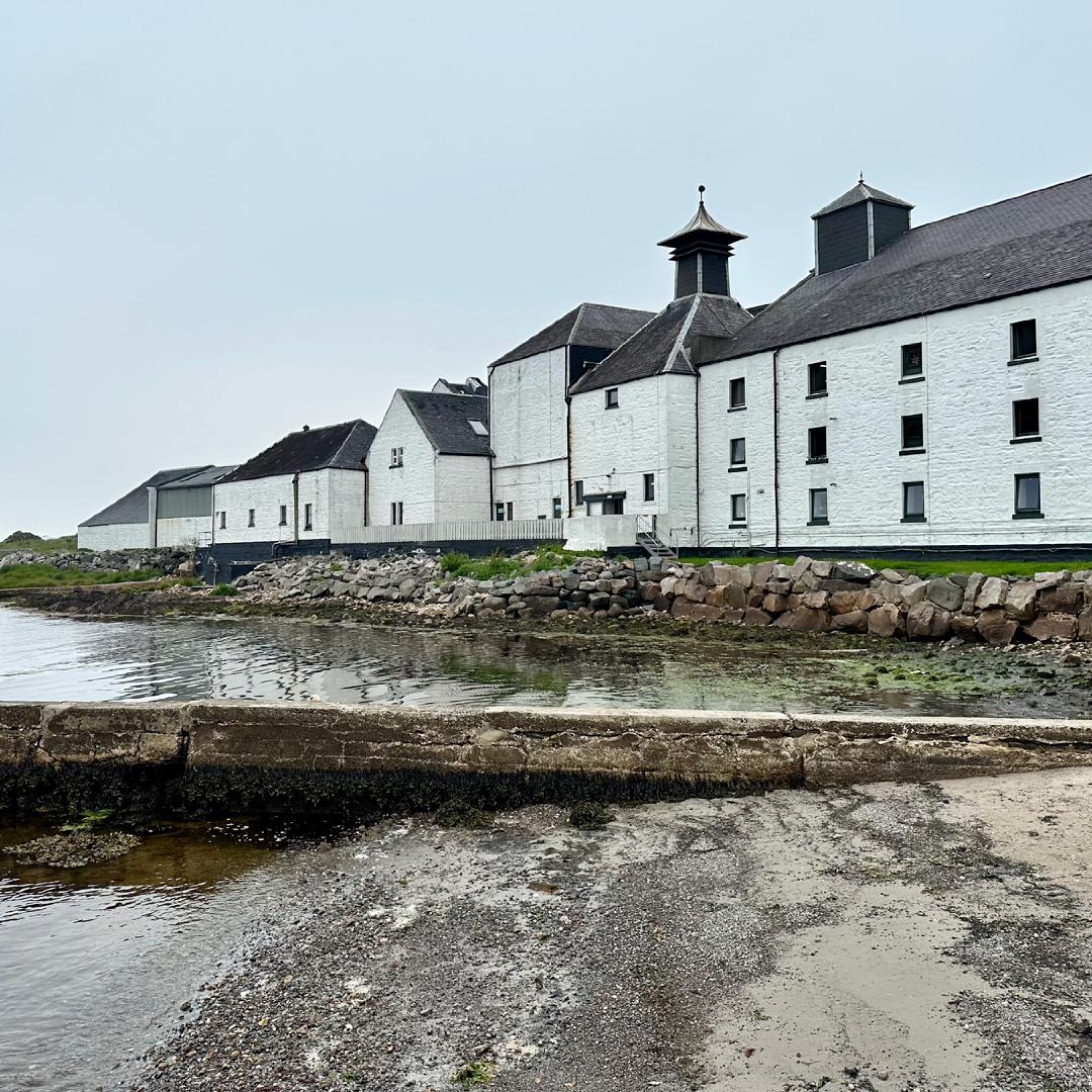 A view of the white brick Laphraoig distillery and visitor's centre