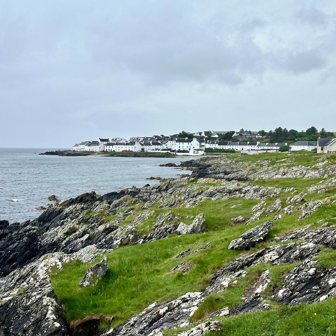 A view of Port Charlotte, a little collection of white houses on a rugged coast