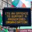 A large LED sign put up by the police that states 'ITS AN OFFENCE TO SUPPORT A PROSCRIBED ORGANISATION'