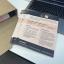 A stack of flyers for Unite stacked on my desk, placed beside a box of 1,000