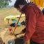 Me stood over an anvil hammering a strip of red hot metal