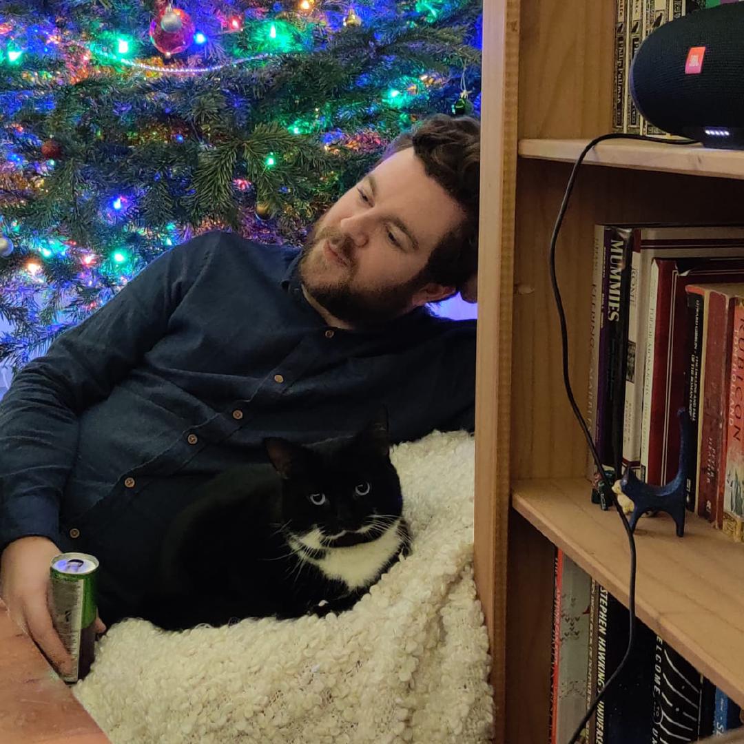 Tootsie and I sharing a beanbag on New Years Eve, with a Christmas tree lighting us