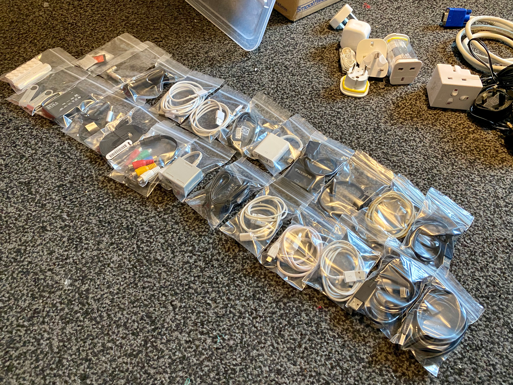 Lots of different cables neatly rolled up in small bags