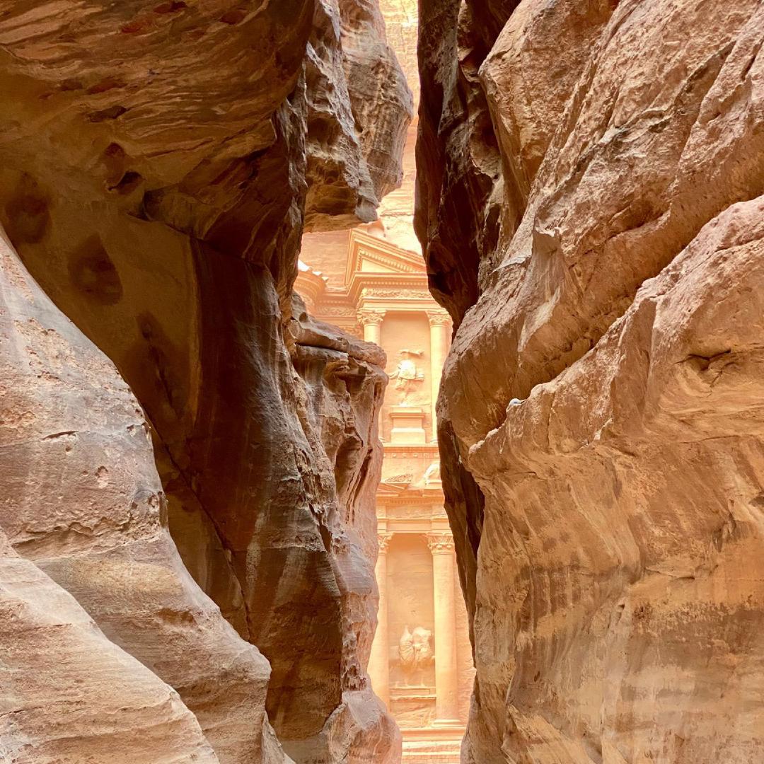 A view of the Treasury at Petra, through a narrow canyon