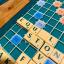 A scrabble board with the word 'equal' played on a triple word score